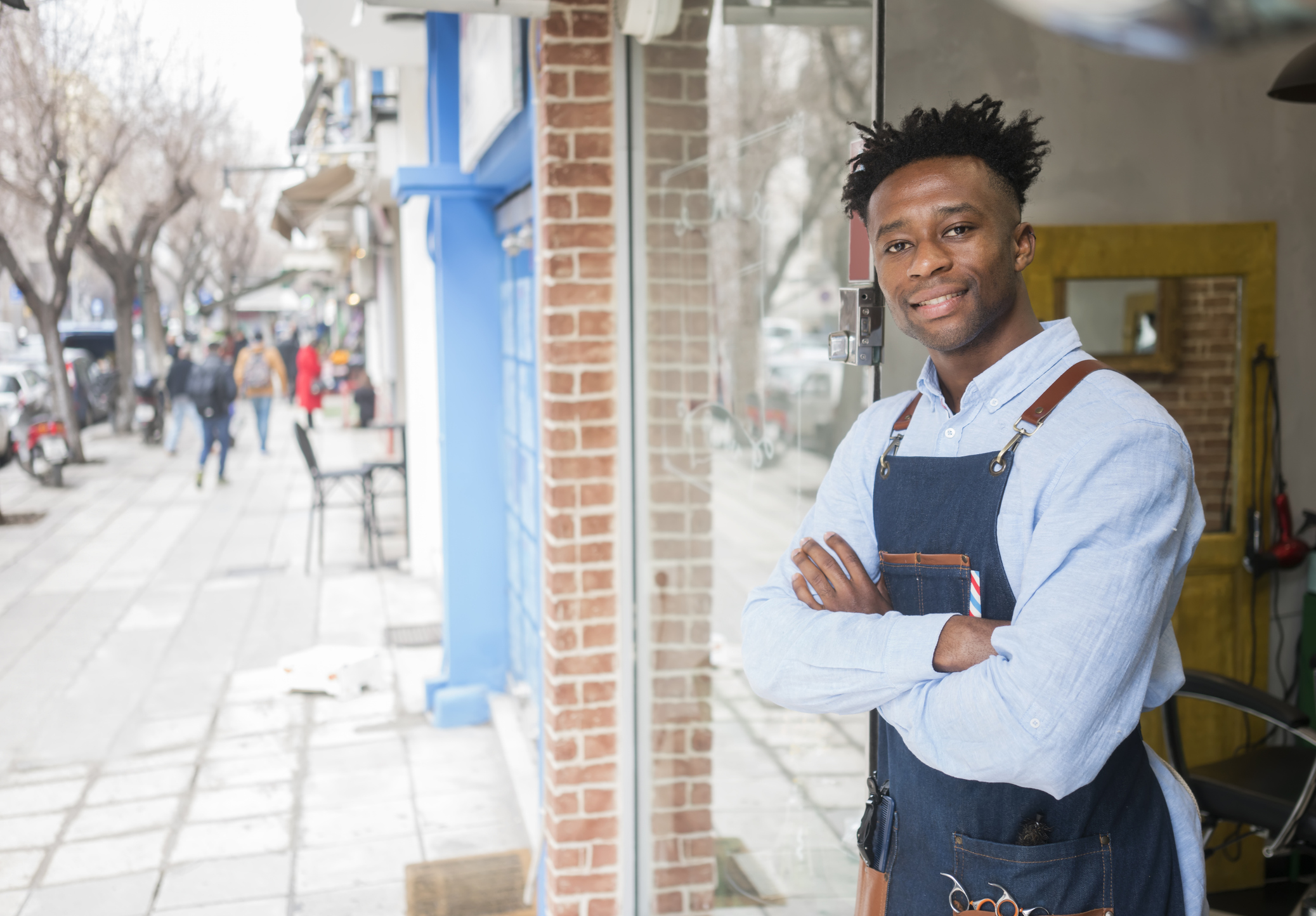 Barber in front of barber shop